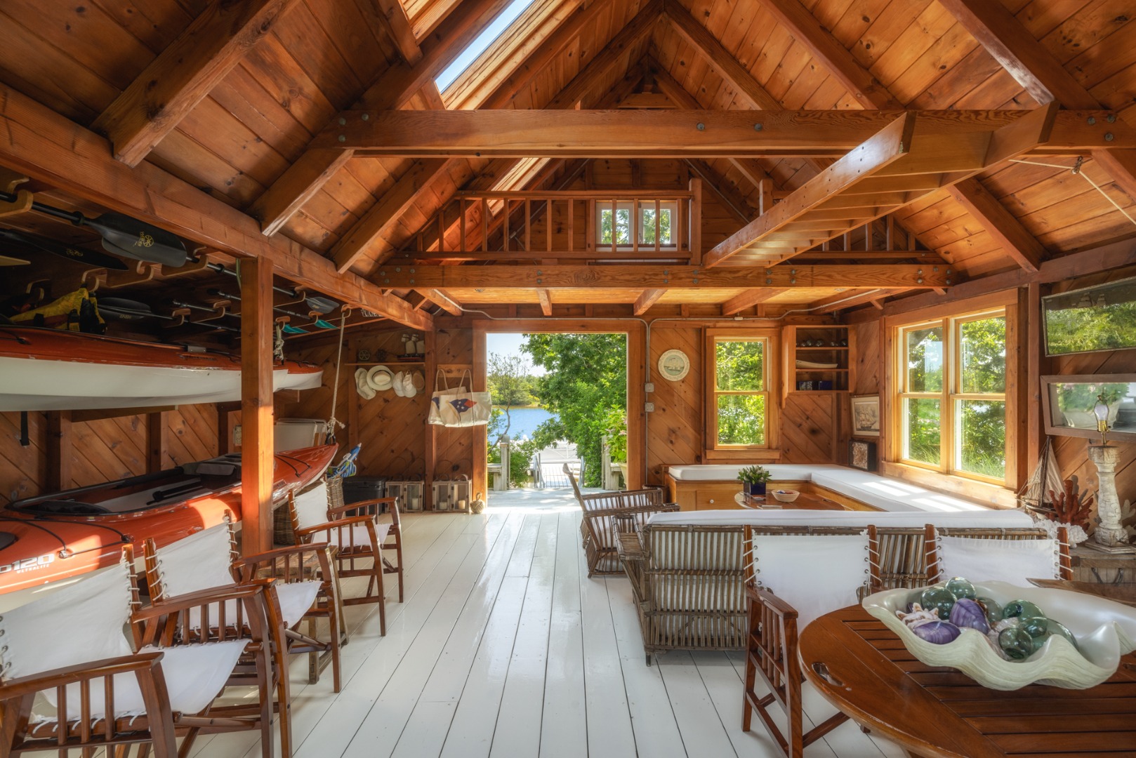 41 Cobbs Hill Road Chilmark, MA 02535 - Photo 22 of 46 a view of a patio with table and chairs potted plants with wooden floor