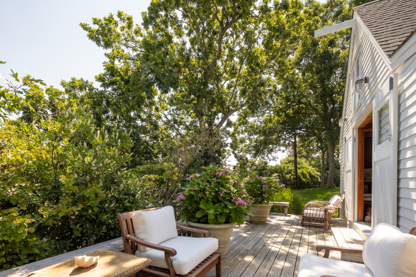 41 Cobbs Hill Road Chilmark, MA 02535 - Photo 23 of 46 a view of a patio with table and chairs and potted plants