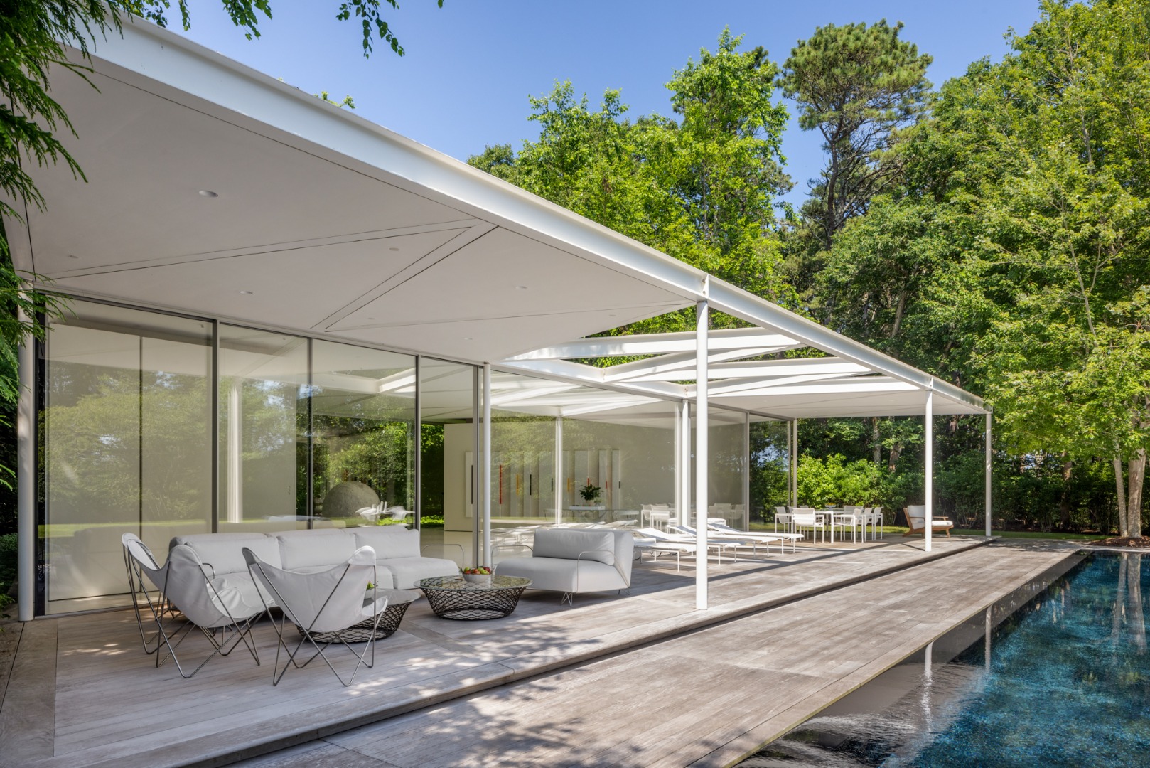 41 Cobbs Hill Road Chilmark, MA 02535 - Photo 27 of 46 a view of a patio with a dining table and chairs under an umbrella