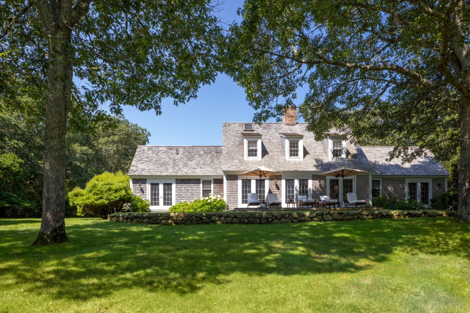 41 Cobbs Hill Road Chilmark, MA 02535 - Photo 38 of 46 a front view of a house with a garden
