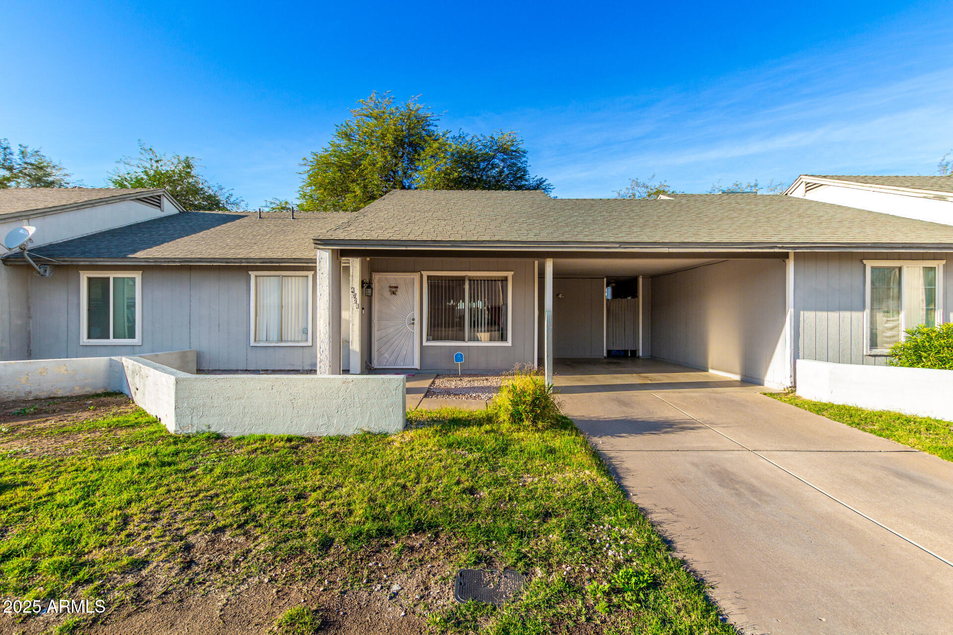 a front view of a house with a garden and yard