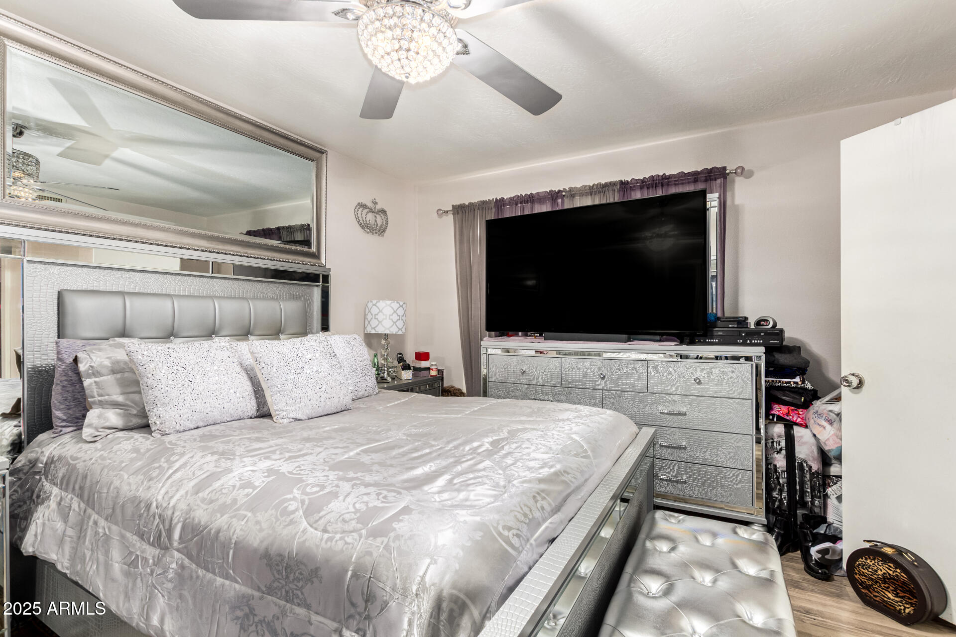 4028 East Carson Road Phoenix, AZ 85042 - Photo 15 of 26 a bedroom with a bed and a flat screen tv