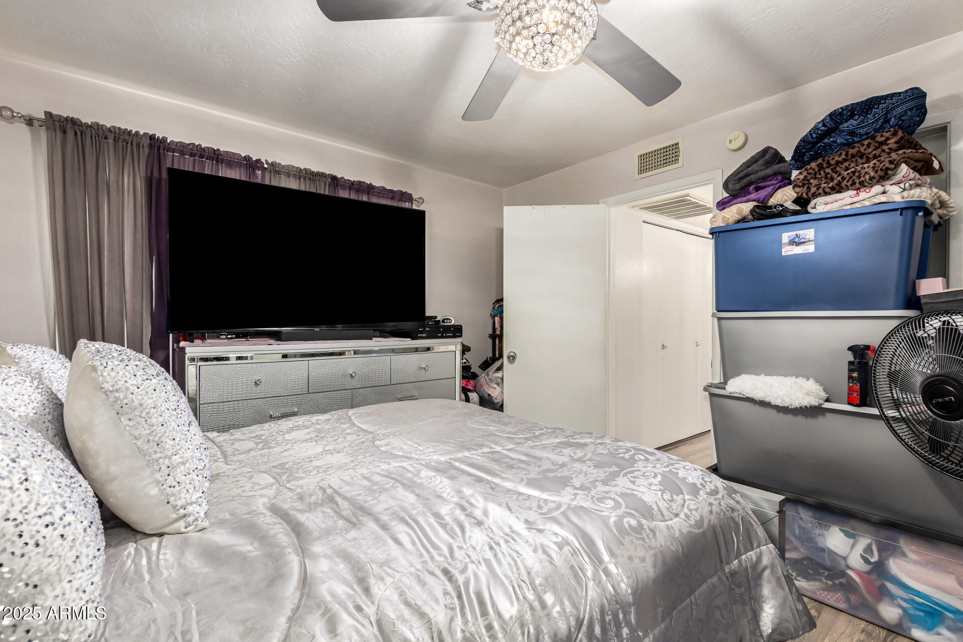 4028 East Carson Road Phoenix, AZ 85042 - Photo 16 of 26 a bedroom with a bed and flat screen tv