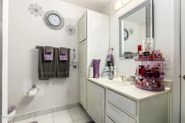 a bathroom with a sink vanity and mirror