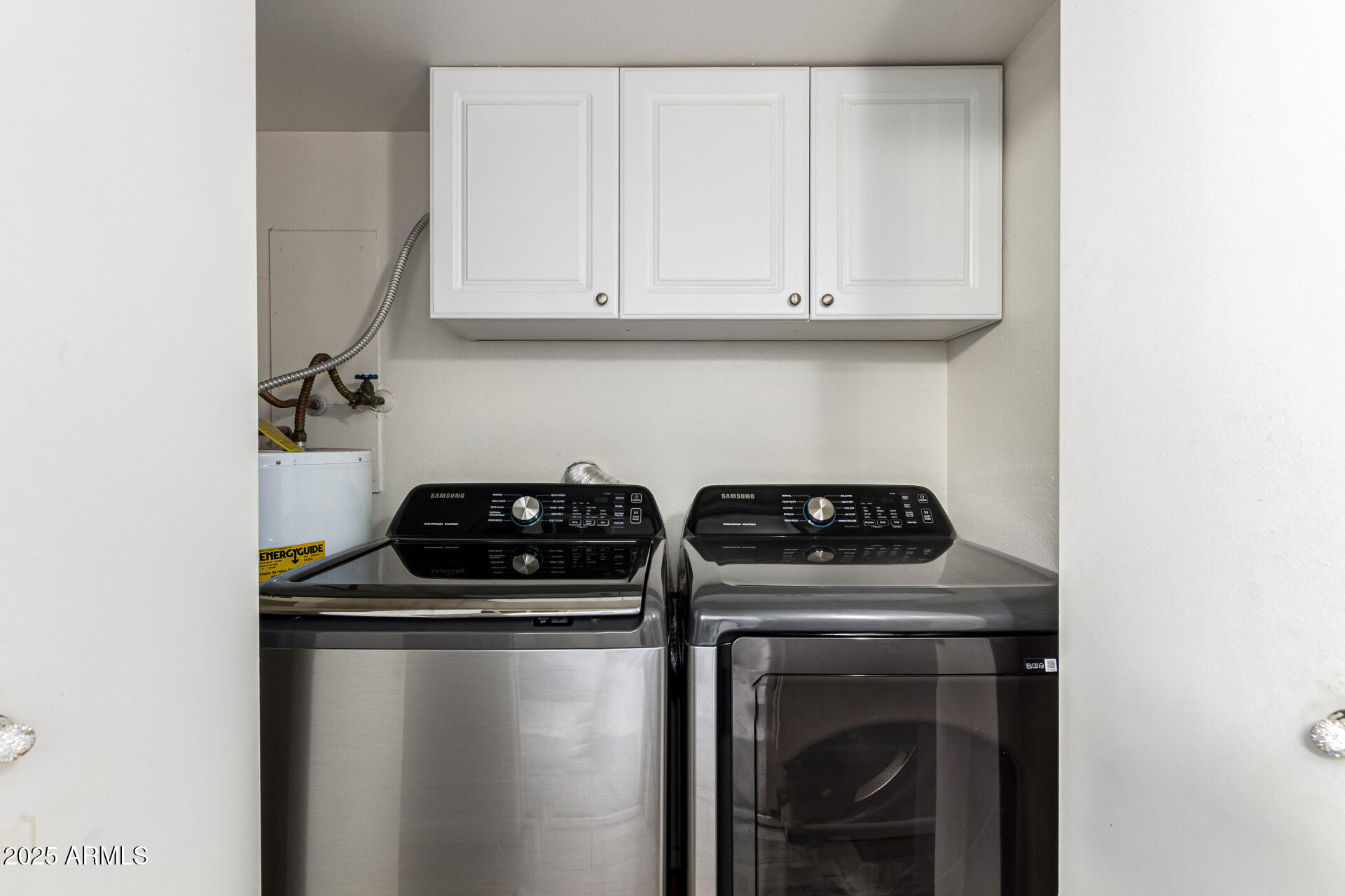 4028 East Carson Road Phoenix, AZ 85042 - Photo 21 of 26 a kitchen with a stove and white cabinets