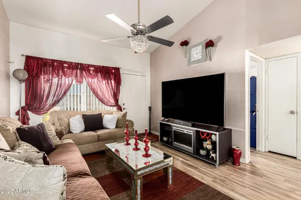 a living room with furniture a flat screen tv and a fireplace