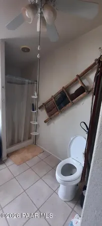 a bed sitting in a bedroom next to a bathroom
