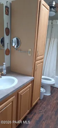 a bathroom with a granite countertop sink toilet and a mirror