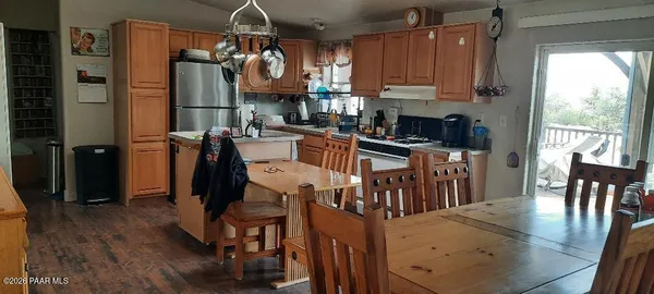 a living room with furniture a fireplace and a chandelier