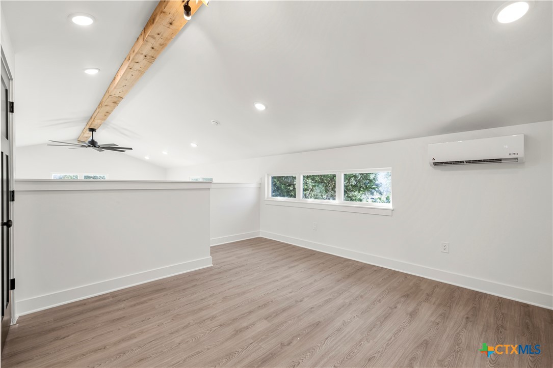 7660 McGregor Park Road Temple, TX 76502 - Photo 13 of 47 an empty room with wooden floor and windows