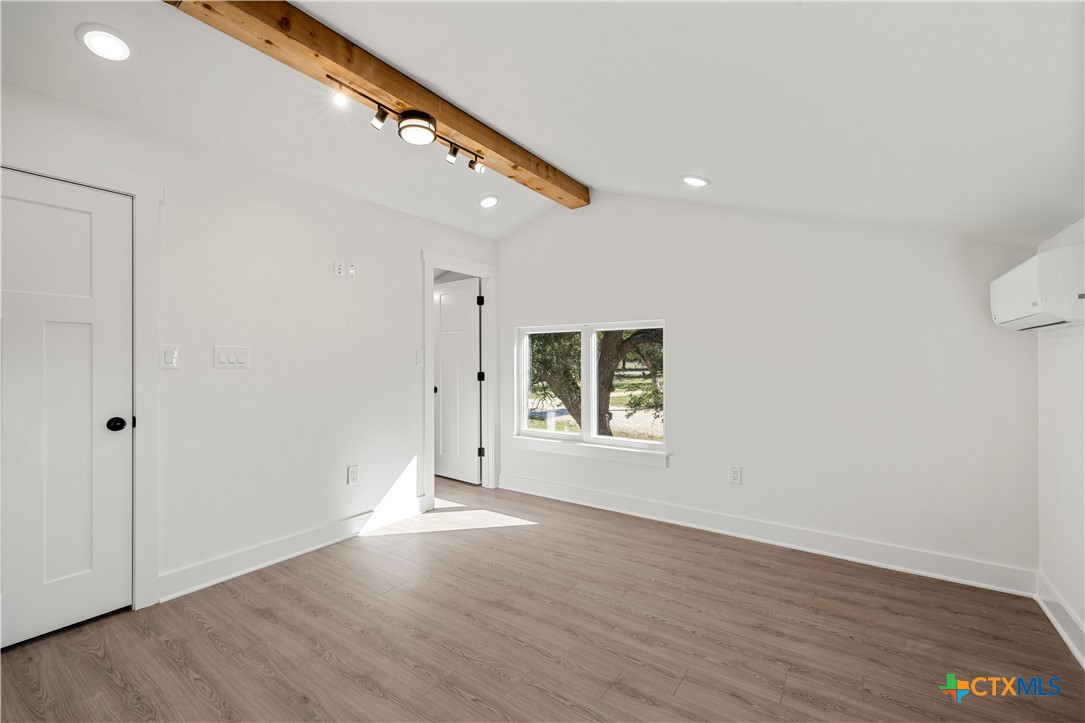 7660 McGregor Park Road Temple, TX 76502 - Photo 17 of 47 a view of an empty room with wooden floor and a window