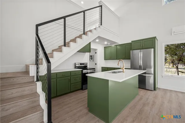 a kitchen with cabinets a sink and a stove
