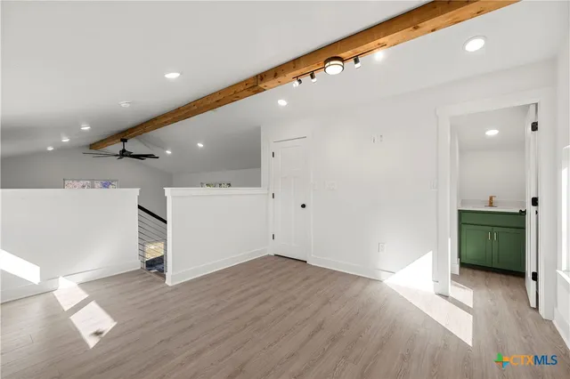 a view of a hallway with wooden floor and a hallway