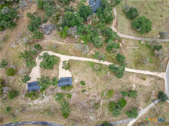 an aerial view of a house with a yard