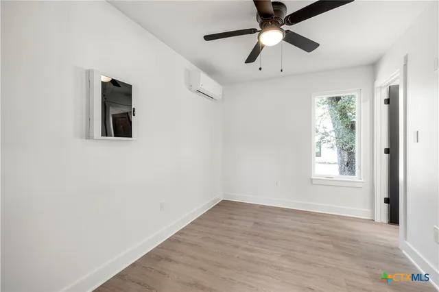 wooden floor in an empty room with a window