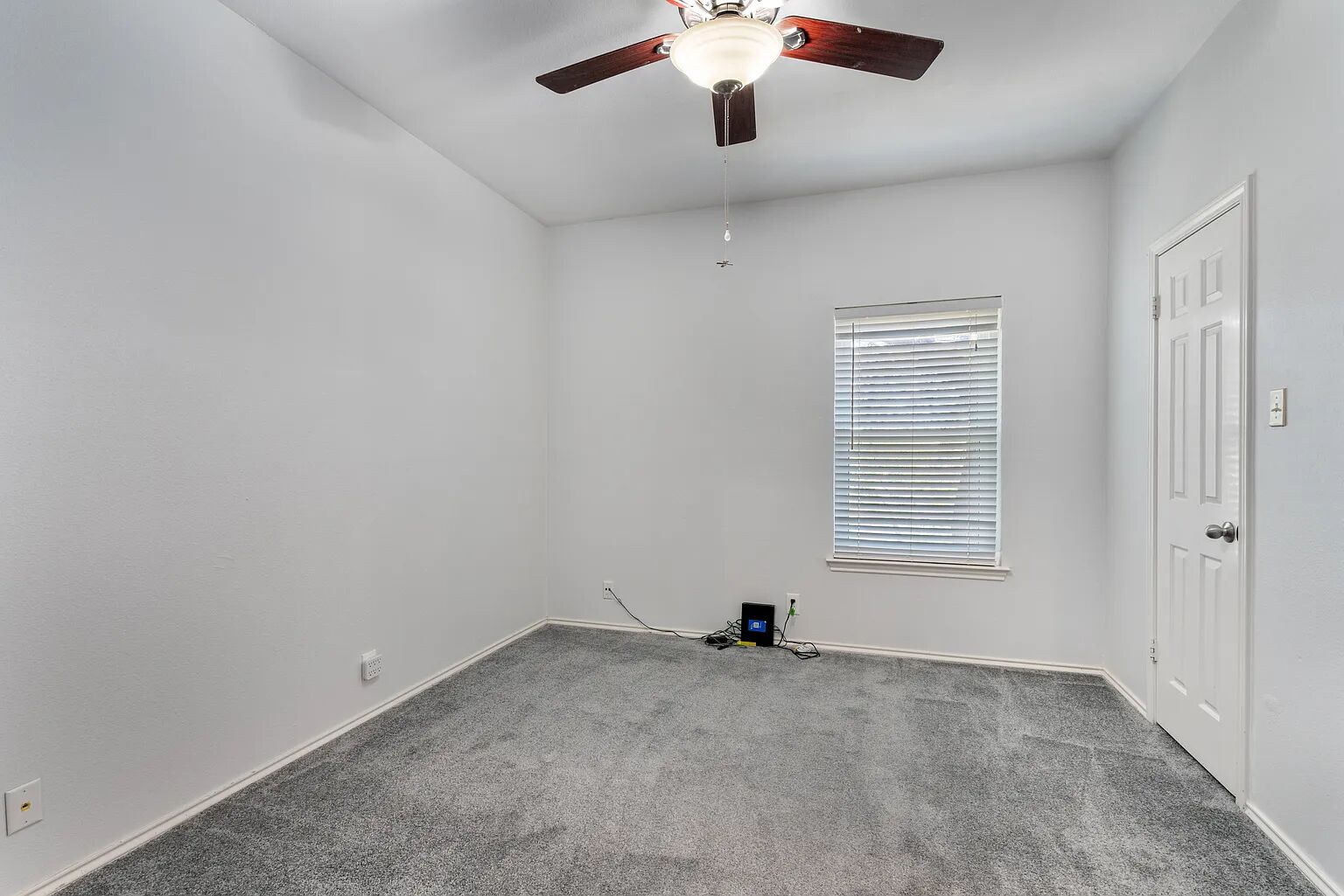 11970 Jollyville Road, Unit 202 Austin, TX 78759 - Photo 11 of 25 A well-lit secondary bedroom provides a versatile space with comfortable carpeting and a cooling ceiling fan.