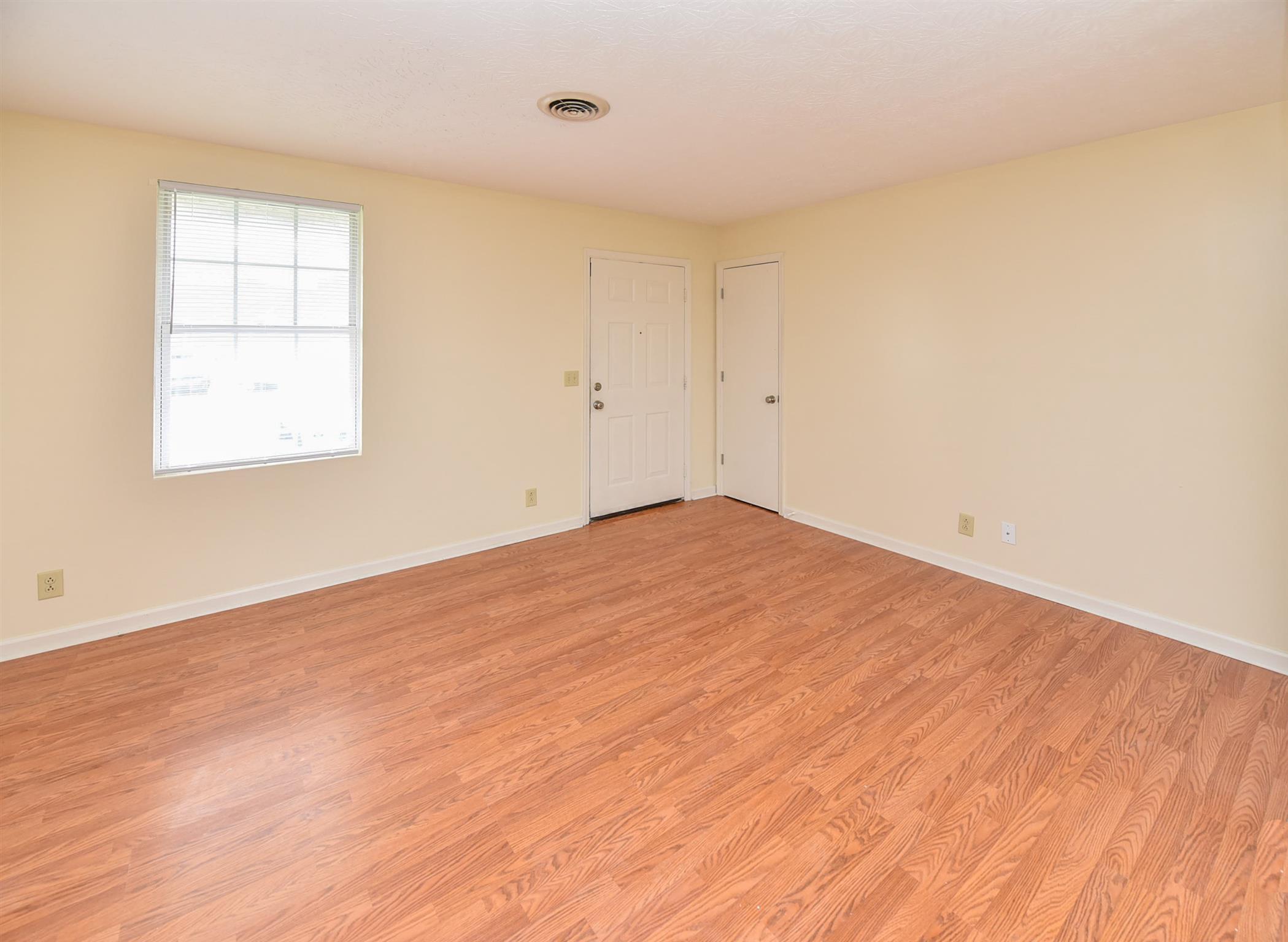 2000 R W Gordon Drive Springfield, TN 37172 - Photo 11 of 21 an empty room with wooden floor and windows