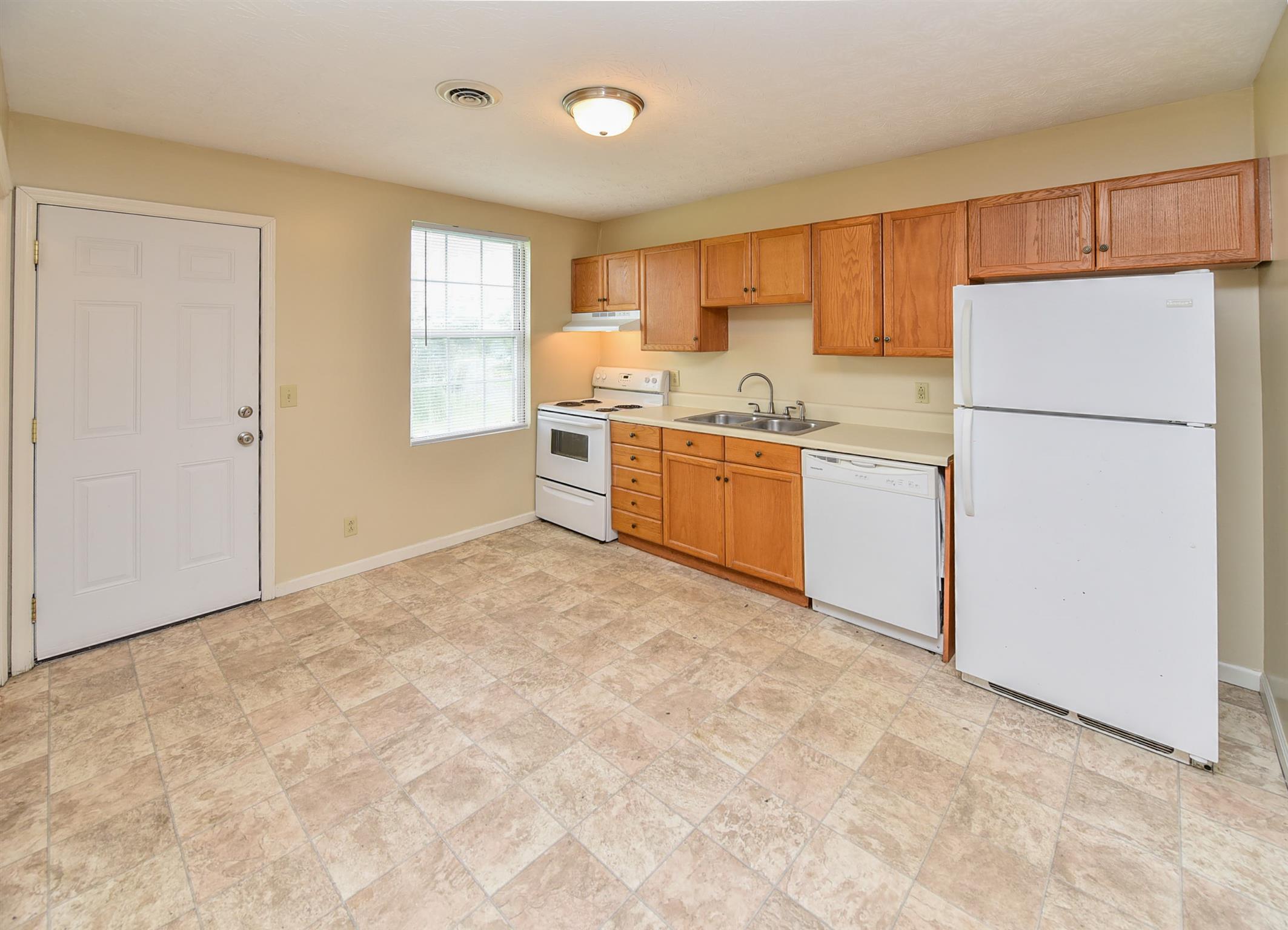 2000 R W Gordon Drive Springfield, TN 37172 - Photo 13 of 21 a kitchen with stainless steel appliances granite countertop a refrigerator sink and cabinets