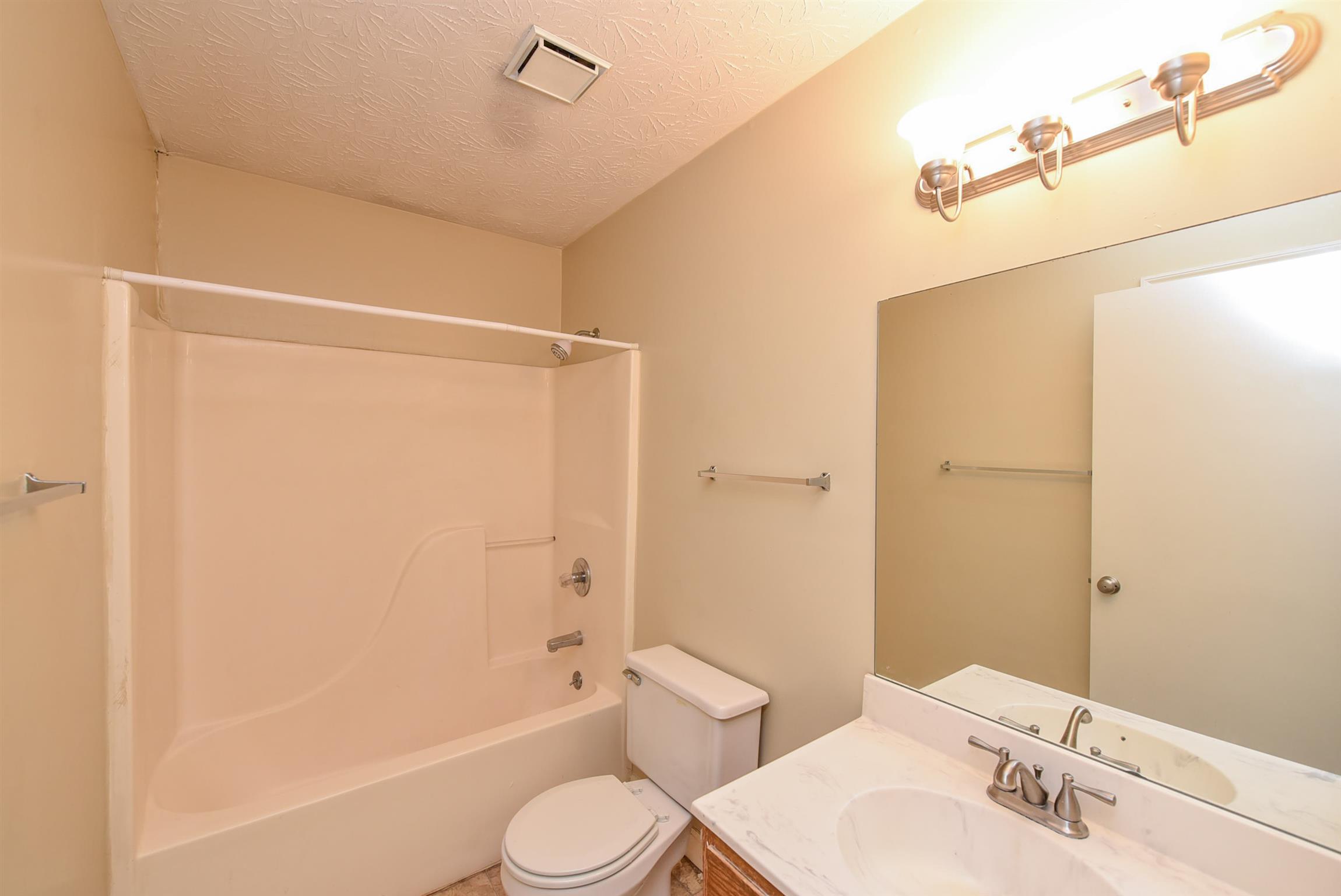 2000 R W Gordon Drive Springfield, TN 37172 - Photo 17 of 21 a bathroom with a bathtub shower sink vanity and toilet