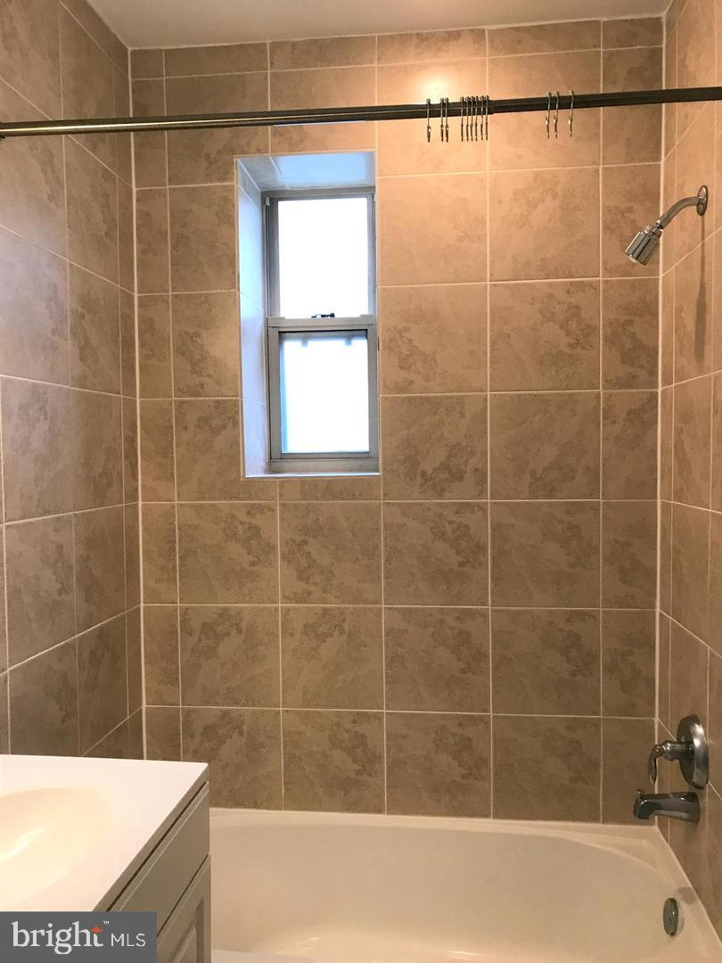 5401-5407 9th Street Northwest, Unit 102 Washington, DC 20011 - Photo 11 of 14 a bathroom with a shower and a bathtub
