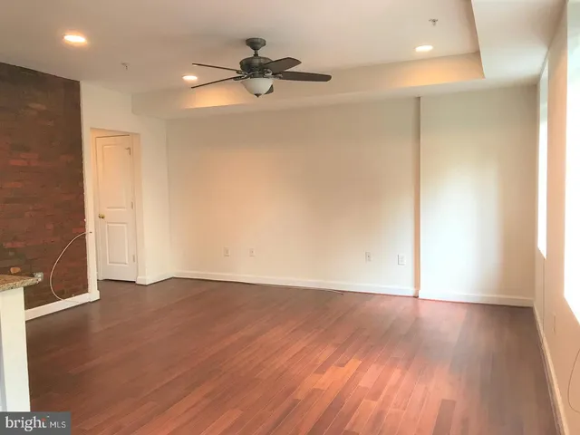 a view of a livingroom with a hardwood floor and a ceiling fan