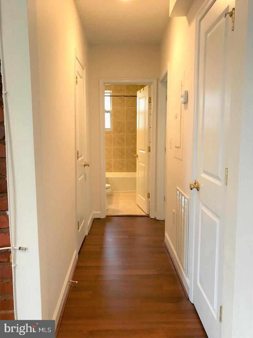 5401-5407 9th Street Northwest, Unit 102 Washington, DC 20011 - Photo 9 of 14 a view of a hallway with wooden floor