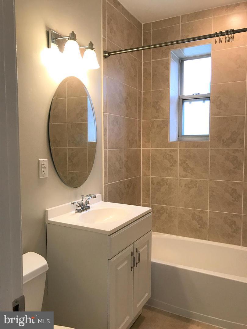 5401-5407 9th Street Northwest, Unit 102 Washington, DC 20011 - Photo 10 of 14 a bathroom with a sink toilet and shower