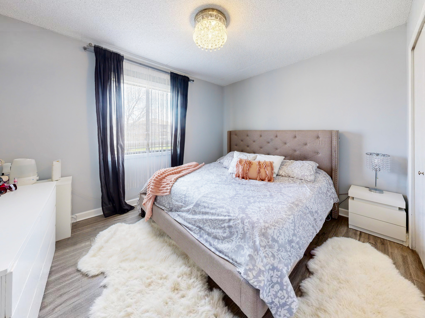 1215 Chalet Road, Unit 200 Naperville, IL 60563 - Photo 5 of 15 a bedroom with a bed and a chandelier