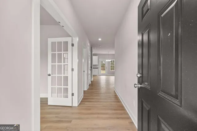 a view of a hallway with wooden floor