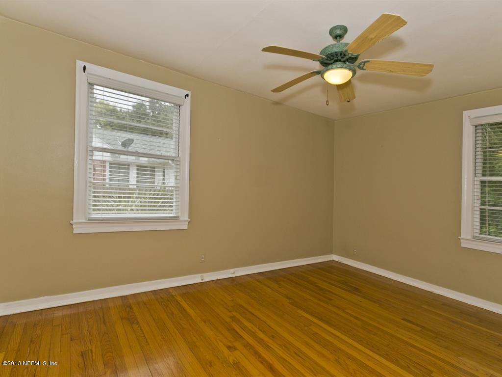4030 Dover Road Jacksonville, FL 32207 - Photo 13 of 21 a view of an empty room with wooden floor and a window