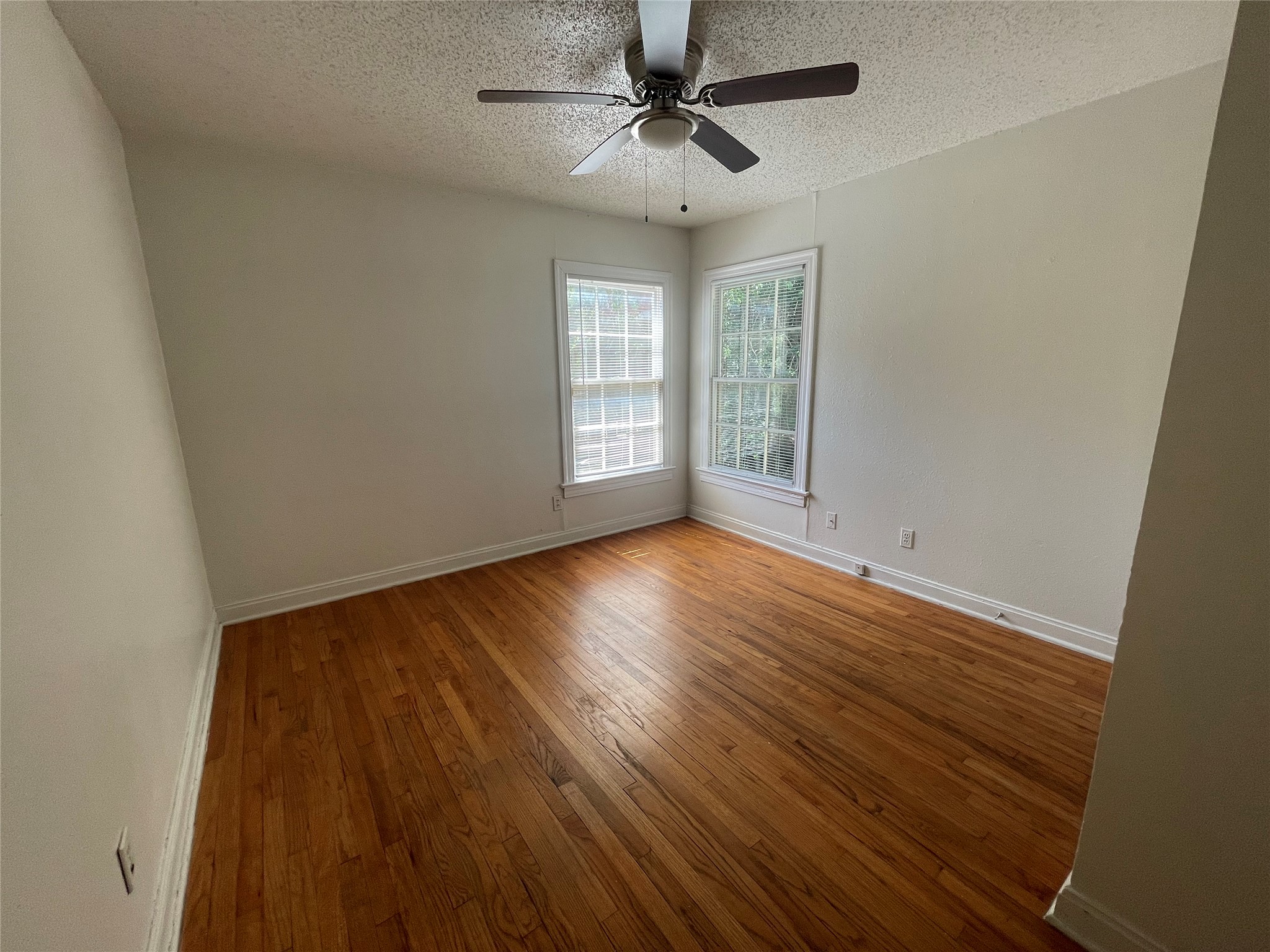 819 East 31st Street Austin, TX 78705 - Photo 11 of 19 wooden floor in an empty room with a window