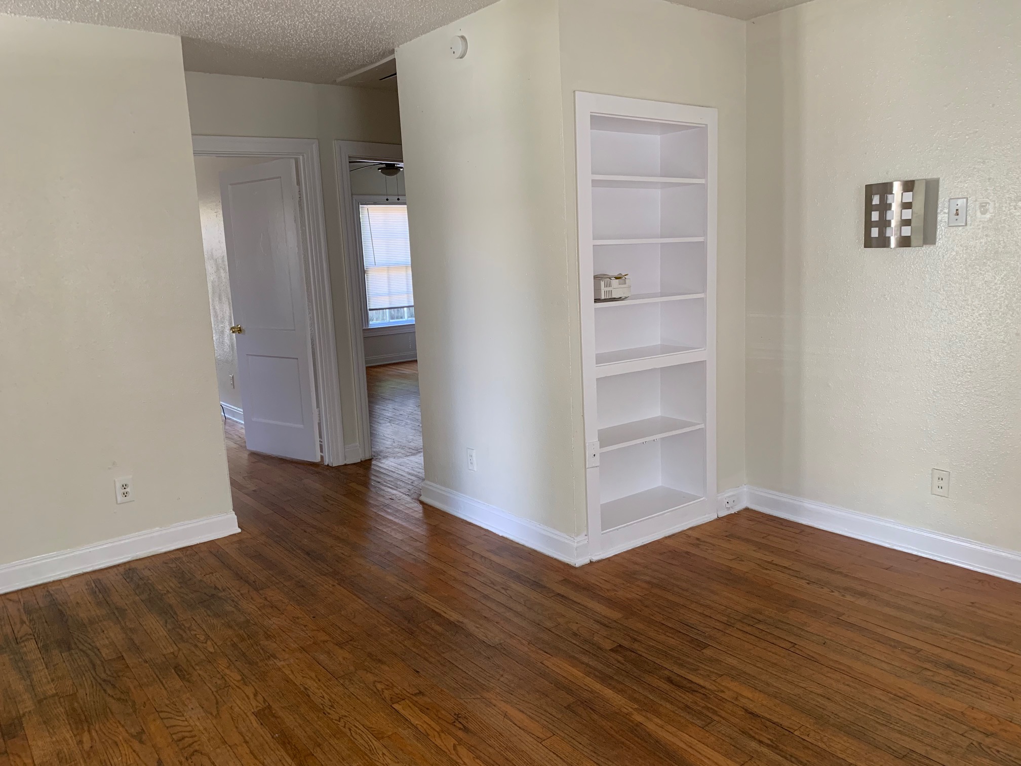 819 East 31st Street Austin, TX 78705 - Photo 4 of 19 an empty room with wooden floor & closet