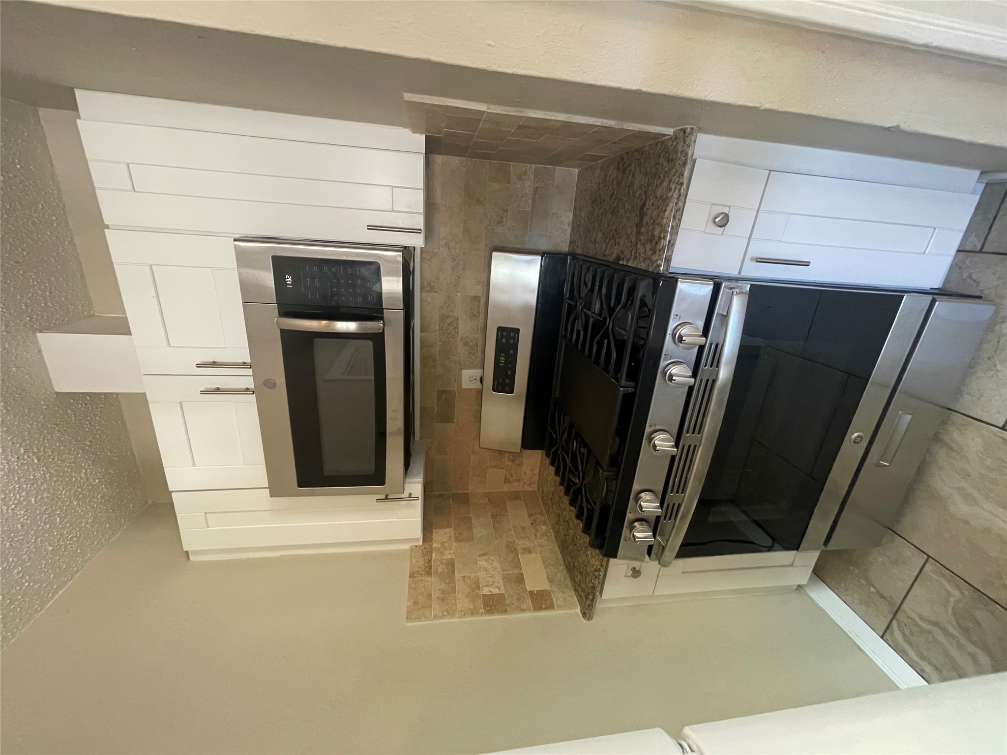819 East 31st Street Austin, TX 78705 - Photo 7 of 19 a kitchen with granite countertop a stove and a microwave