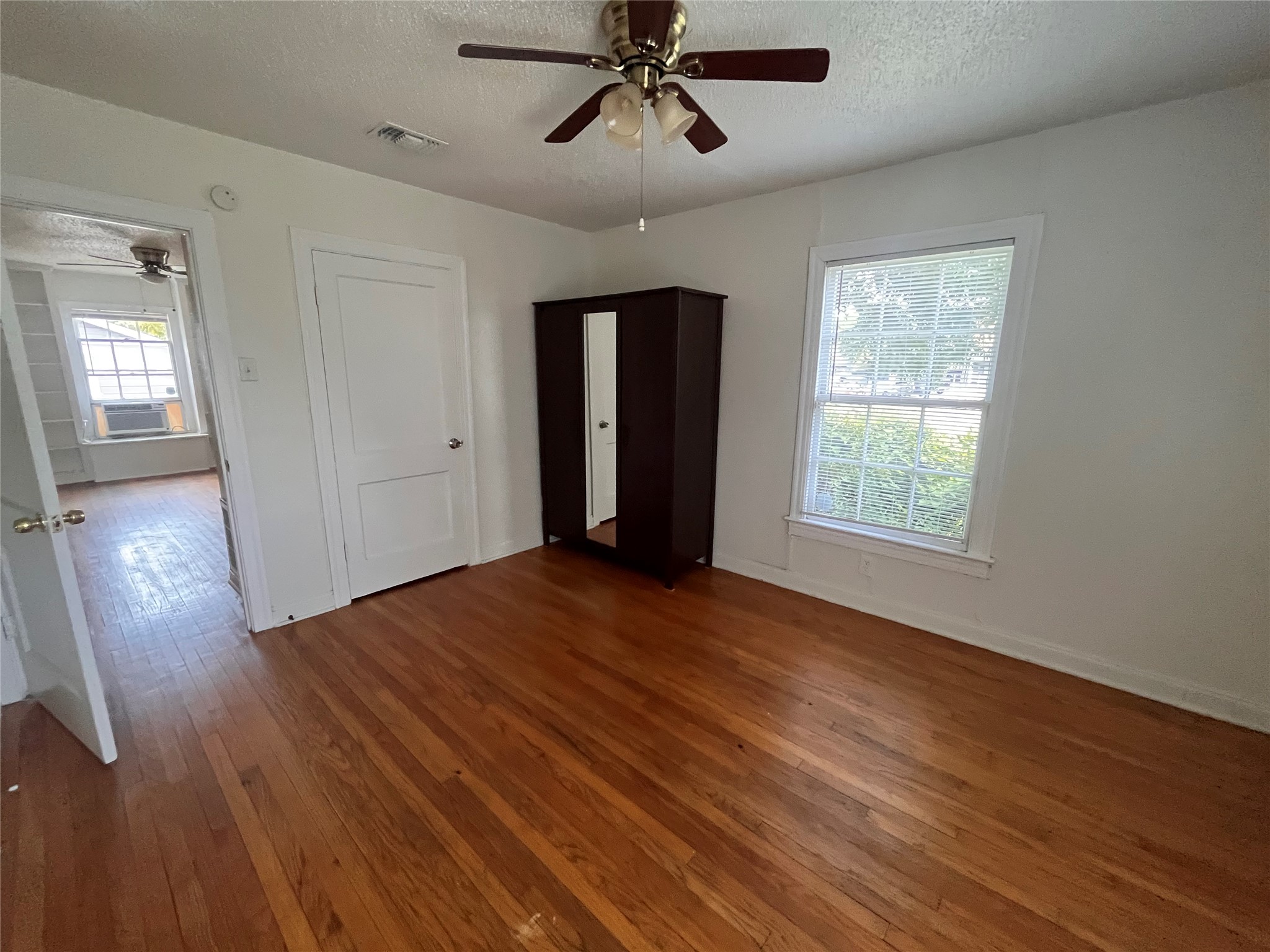 819 East 31st Street Austin, TX 78705 - Photo 9 of 19 a view of an empty room with wooden floor and a window