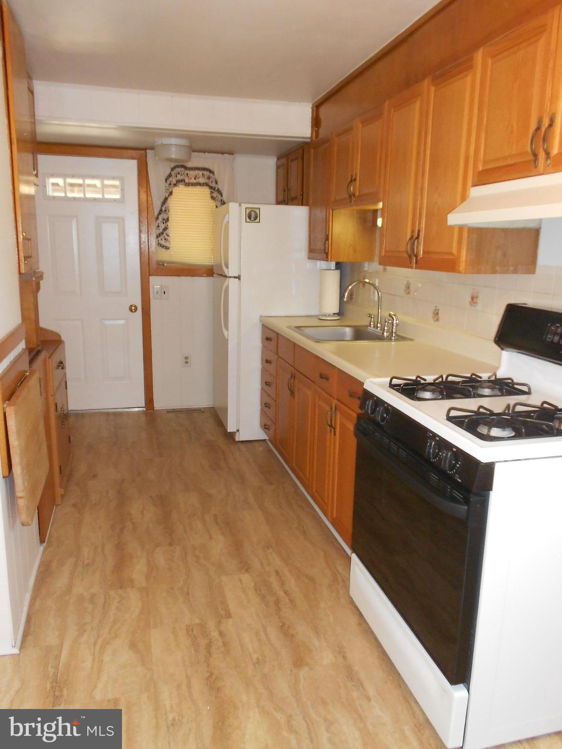 8224 Oakleigh Road Baltimore, MD 21234 - Photo 9 of 26 a kitchen with granite countertop a sink a stove and refrigerator