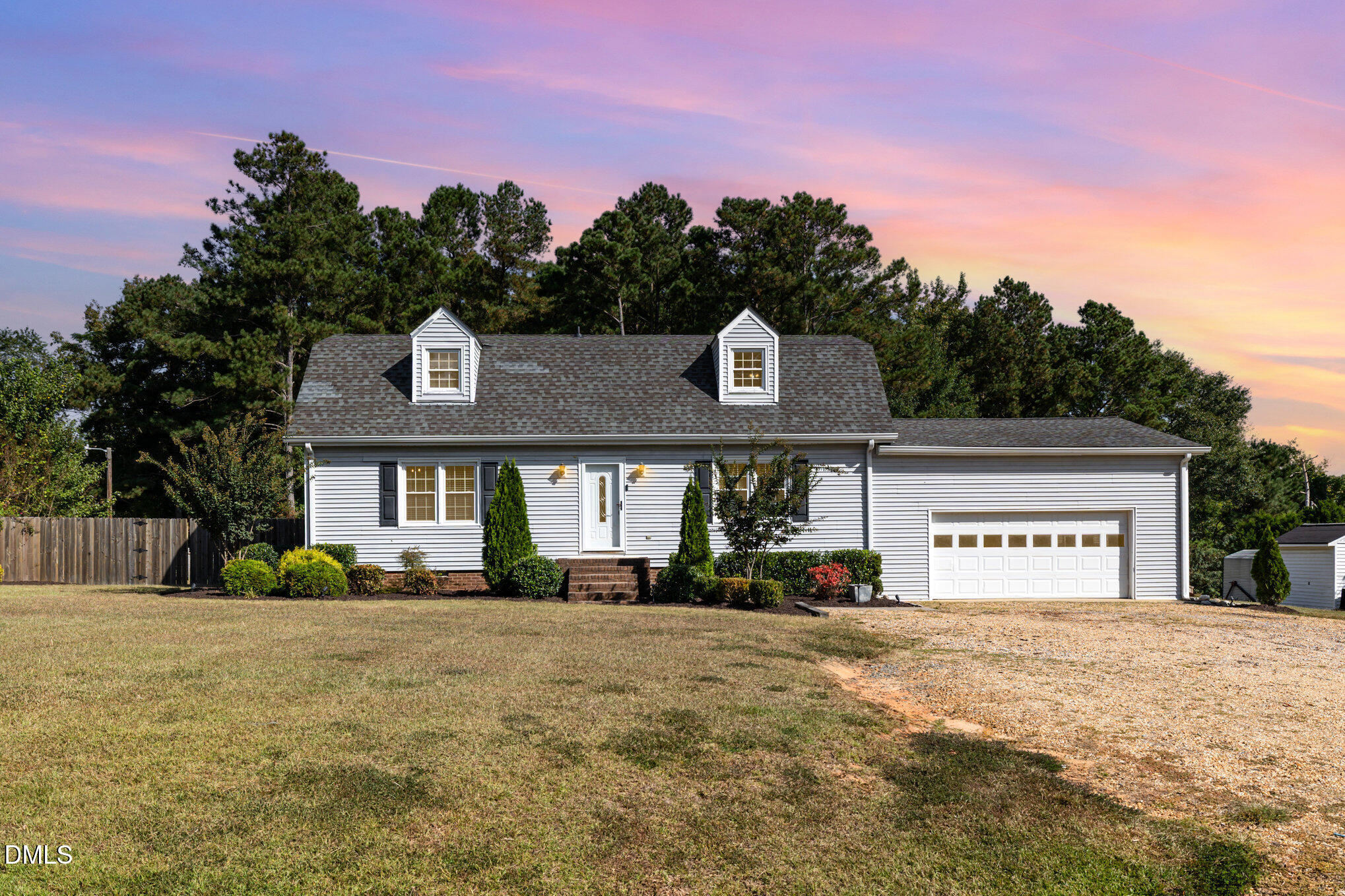 a front view of a building with a garden