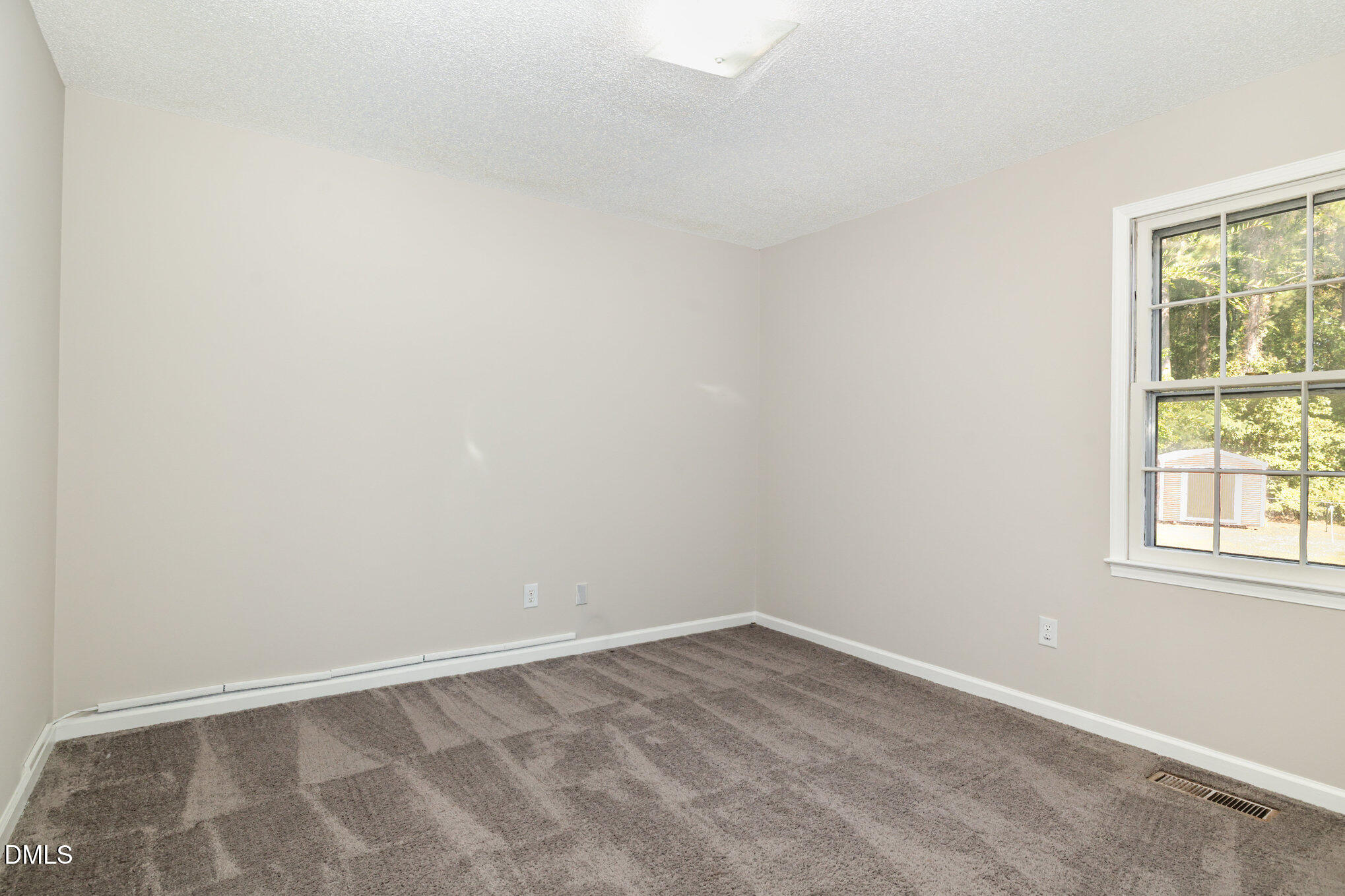 414 Aquilla Road Benson, NC 27504 - Photo 15 of 30 an empty room with a window