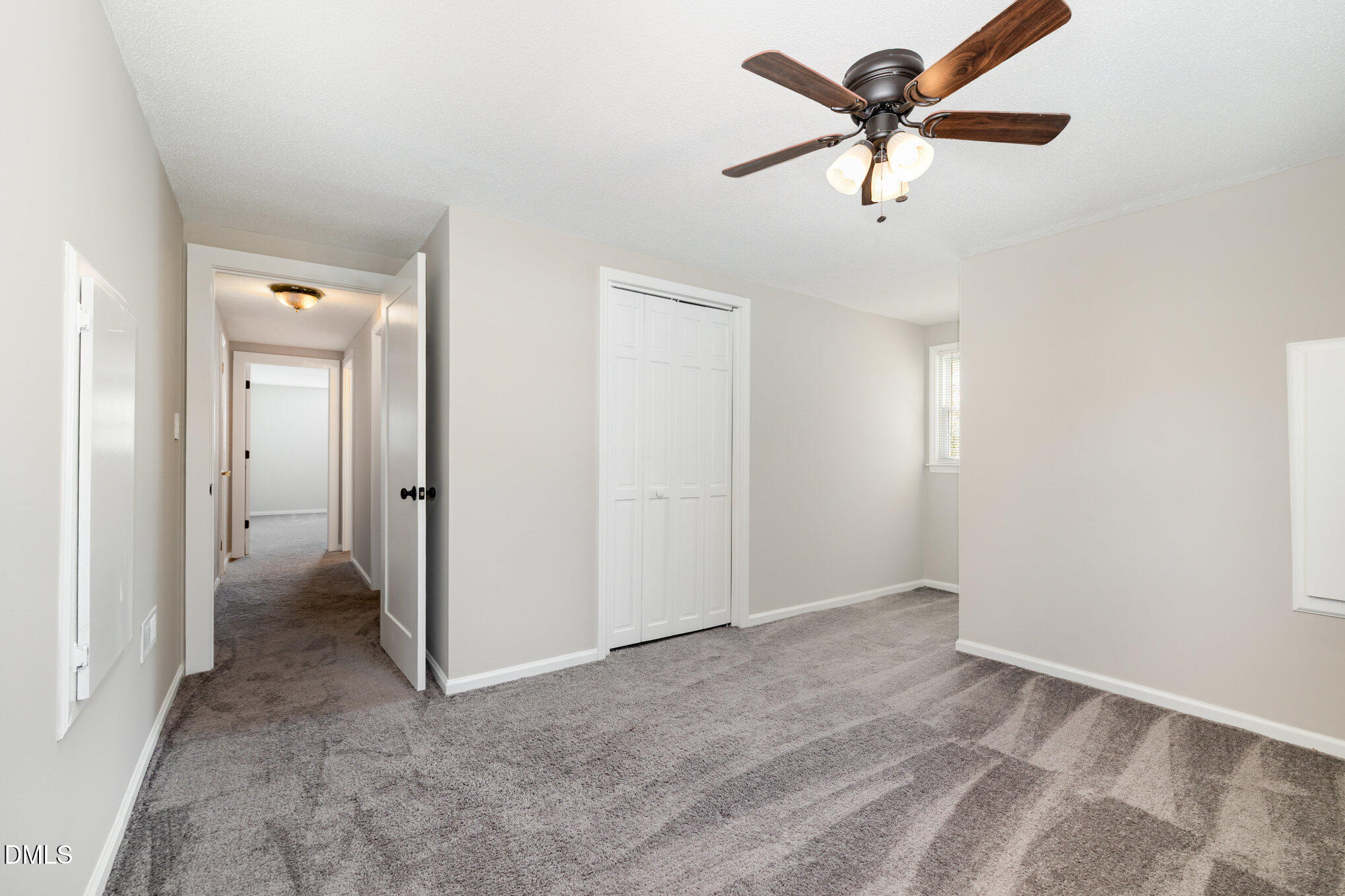 414 Aquilla Road Benson, NC 27504 - Photo 18 of 30 a view of an empty room and a ceiling fan