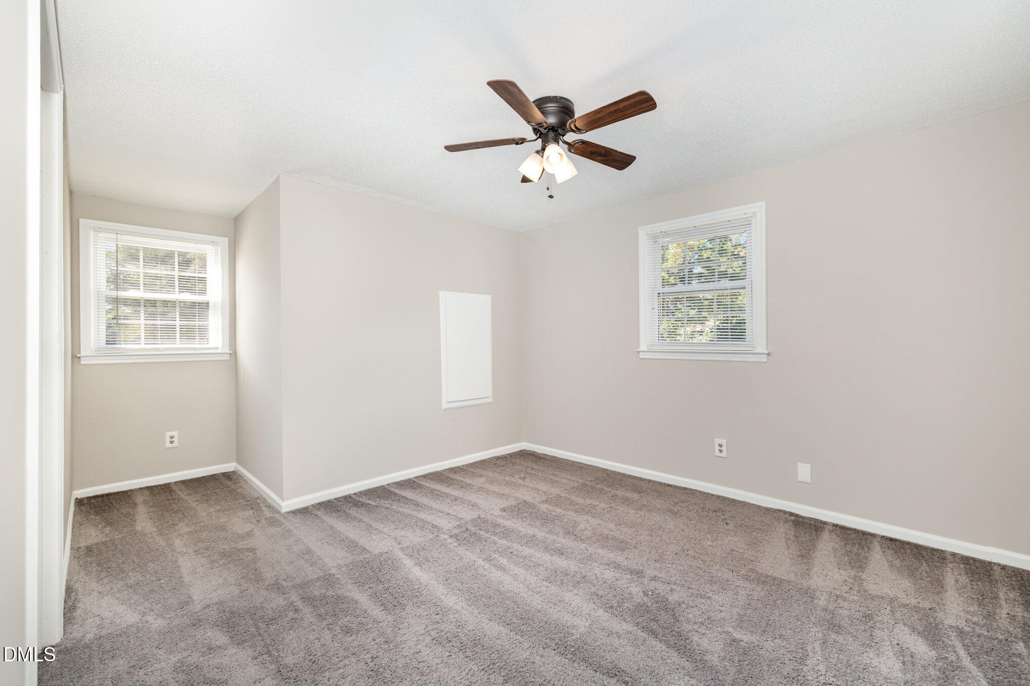 414 Aquilla Road Benson, NC 27504 - Photo 19 of 30 a view of a big room with wooden floor and windows