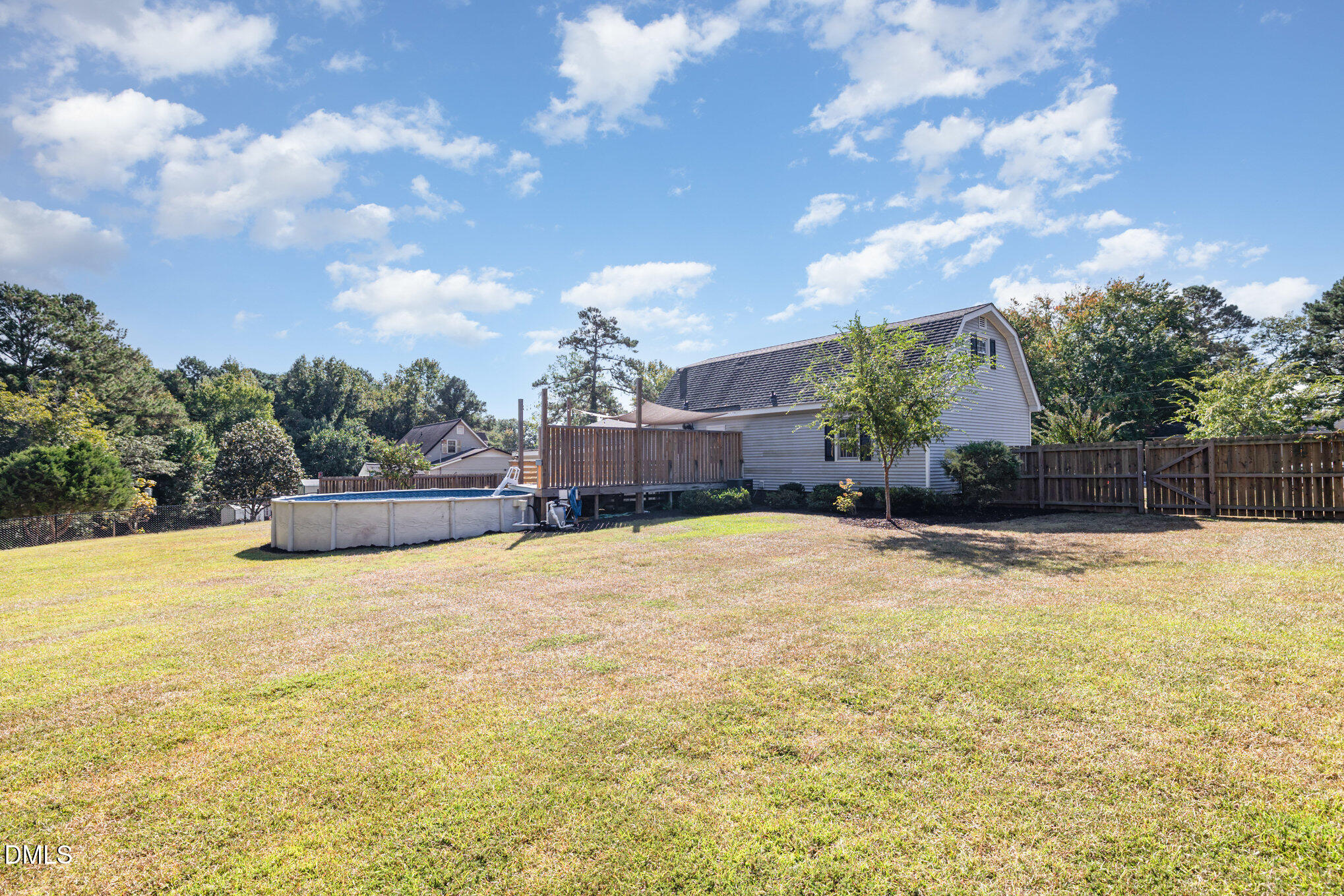 414 Aquilla Road Benson, NC 27504 - Photo 26 of 30 a swimming pool with yard and trees in the background