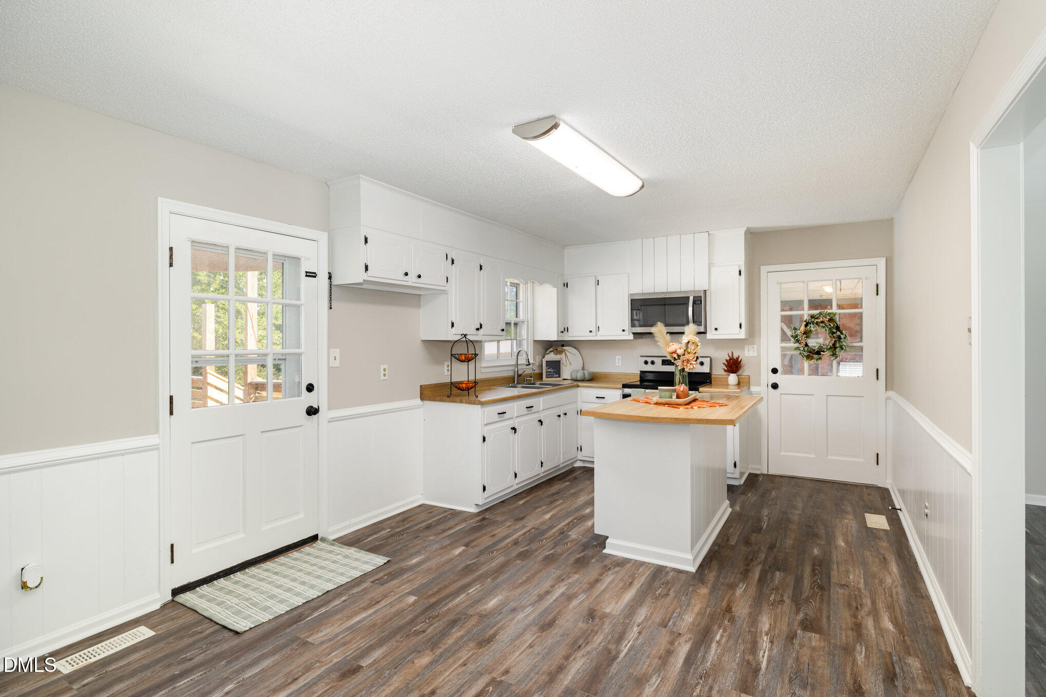 414 Aquilla Road Benson, NC 27504 - Photo 7 of 30 a kitchen with sink cabinets and wooden floor