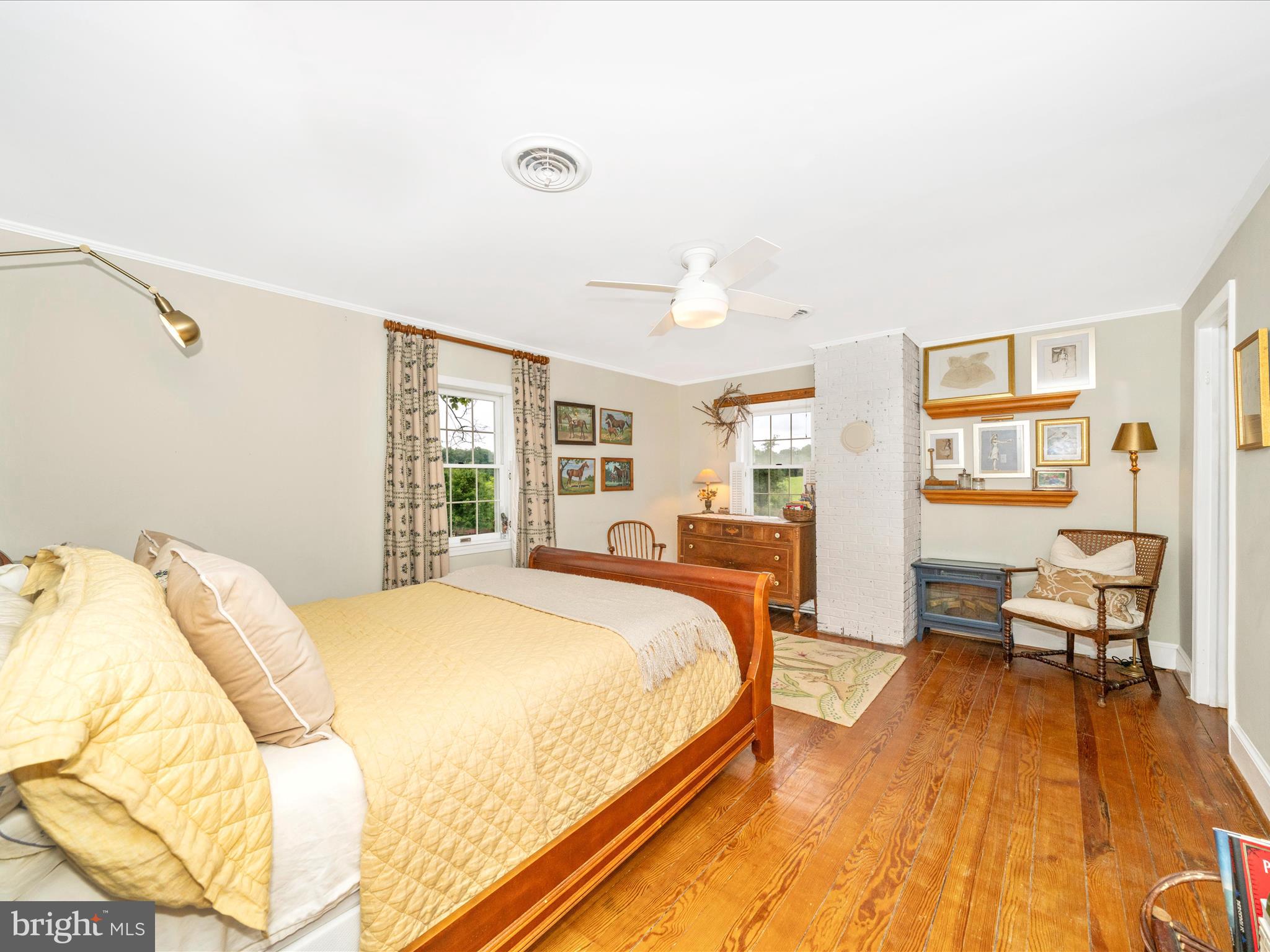 9000 Reichs Ford Road Frederick, MD 21704 - Photo 30 of 44 a spacious bedroom with a bed a table and large windows