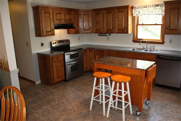 45 Tyler Road Townsend, MA 01469 - Photo 6 of 20 a kitchen with granite countertop wooden cabinets and stainless steel appliances