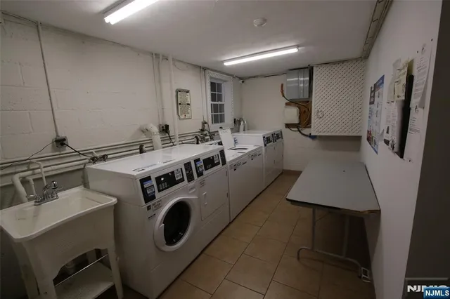 a utility room with dryer washer and a sink