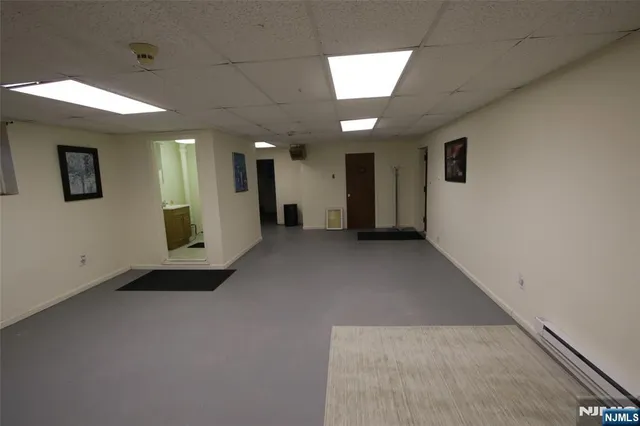 an empty room with chandelier and windows