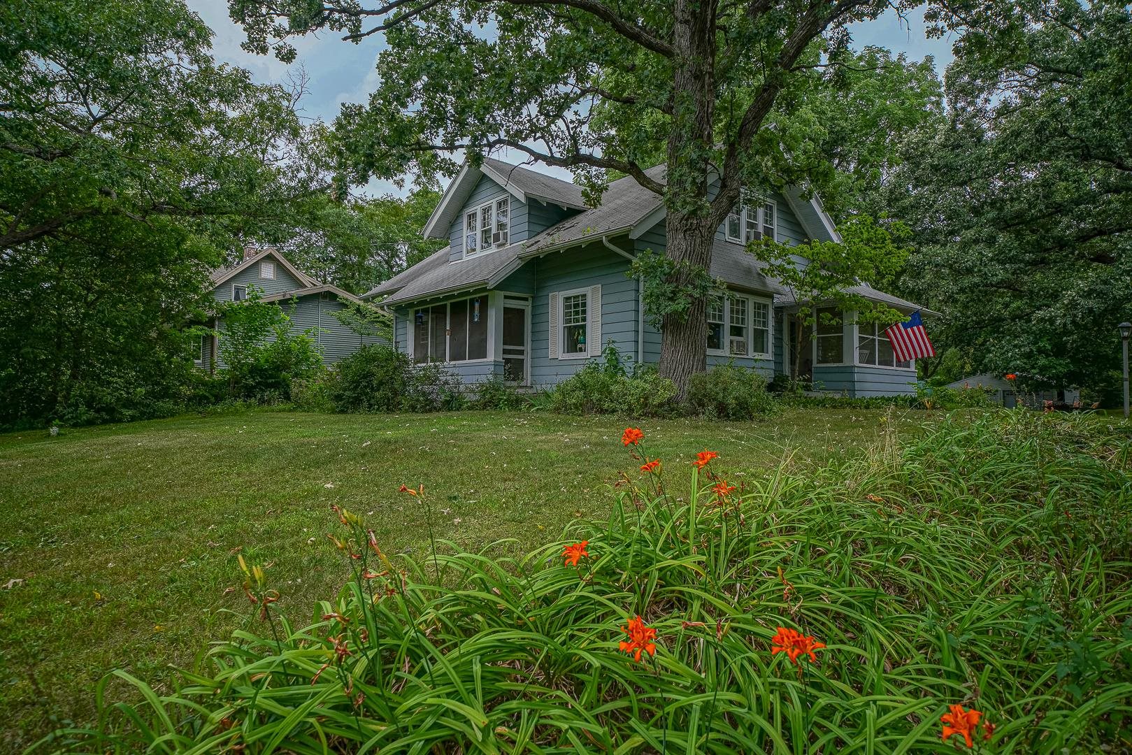 a front view of house with yard and green space