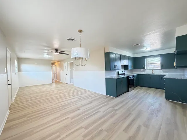 a kitchen with a sink dishwasher a stove and a refrigerator
