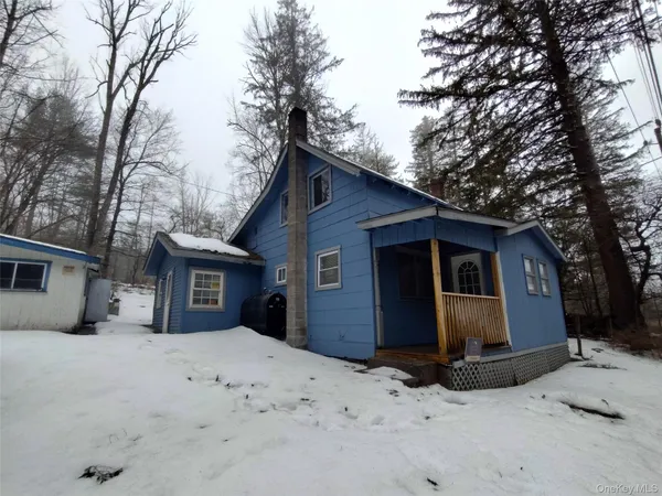 a view of a house with a yard covered in snow