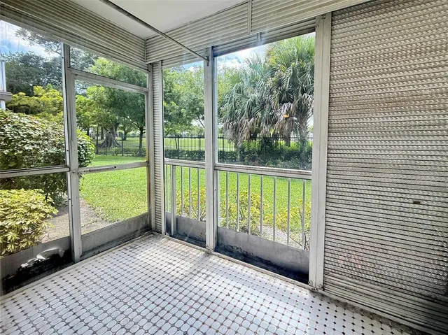 a view of a deck with wooden floor and a yard