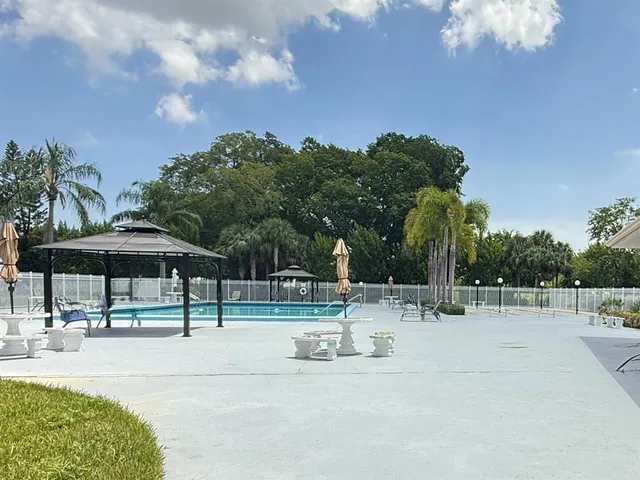 a swimming pool with an outdoor seating